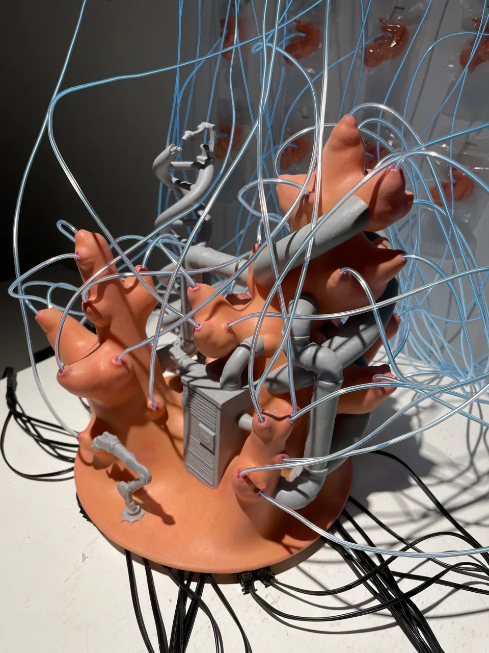 The sculpture from another side, the black cables spilling off the plinth.