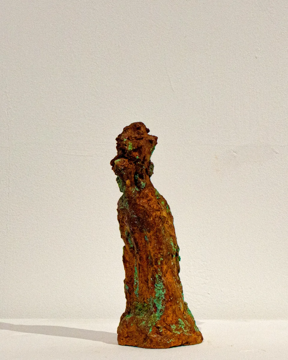 From the side, the head bent over the shoulder.